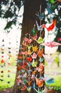 bright coloured paper cranes wedding backdrop outside