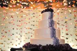 origami paper cranes backdrop to wedding cake