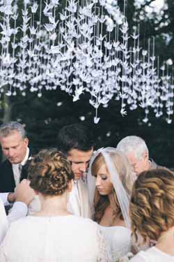 white paper cranes origami backdrop outdoor wedding ceremony