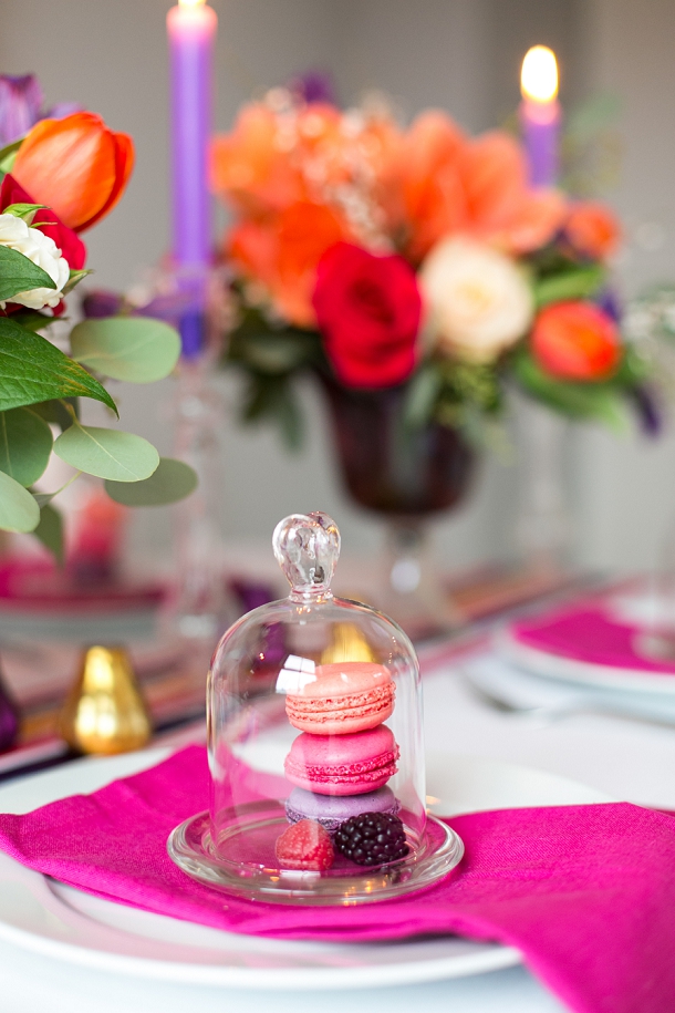 mini glass bell jar with macaroons fruit in bloved wedding styling 