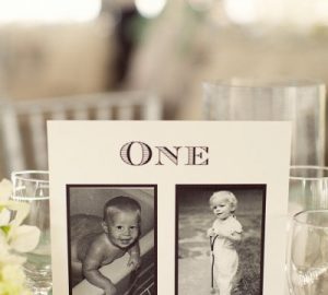 wedding table numbers with photos of the bride and groom at the age