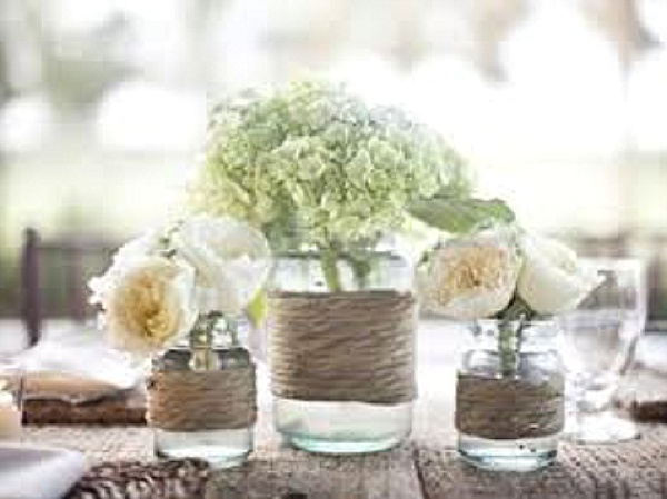 jam jars with twine and flowers rustic wedding centrepiece