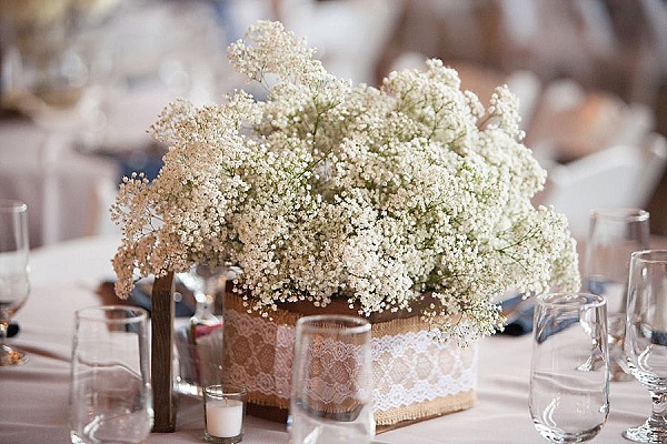 square vase covered in hessian lace with gypsophilia rustic wedding centrepieces