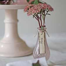 blush pink wedding ideas place a pink bud vase with the name card hanging around the neck on every place setting