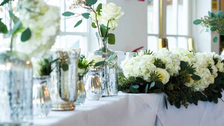 Wedding top table ideas with mercury silver vases and cream roses
