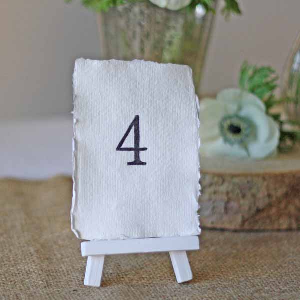 White wooden mini easel for holding wedding table numbers