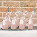 blue and blush pink wedding drinks in milk bottles with straws