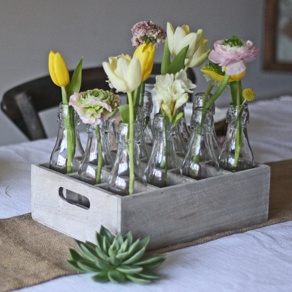 country style wedding centrepiece 12 wooden bottles in woode crate