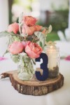 navy blue and blush pink wedding centrepiece on wooden tree slice