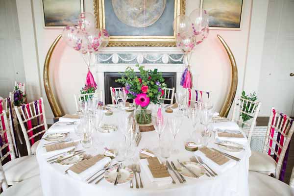 Tree slice Centrepieces with Giant Balloons Real Wedding at Aynhoe Park Bright Pink Fun Wedding Decorations (1)