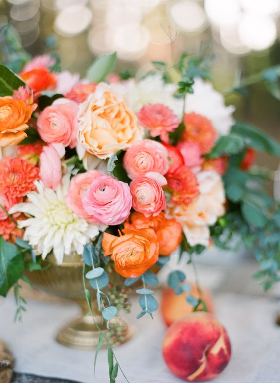 coral wedding centrepieces in gold vases