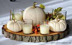 halloween wedding ideas - white pumpkins on tree slice wedding centrepiece