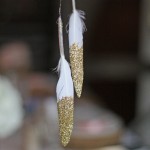 gold glitter feathers by @theweddingomd - metallic wedding ideas