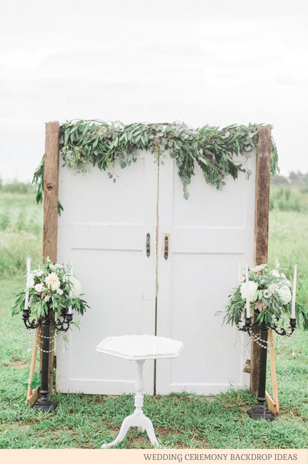 wooden doors with foliage - wedding ceremony backdrop ideas by @theweddingomd