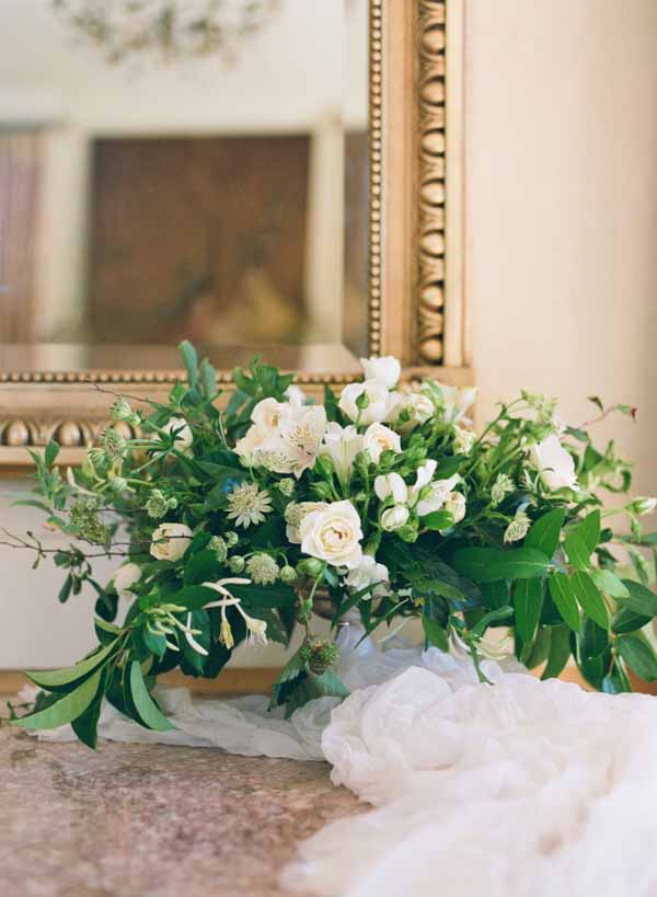 white cotton table runners on wedding entrance tables