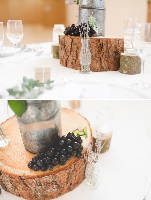 Rustic wedding centrepiece with glass bottles and tree slices - available from @theweddingomd