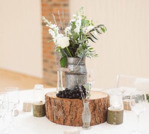 featured image How to style a milk churn wedding centrepiece - milk churns and tree slices available from @theweddingomd