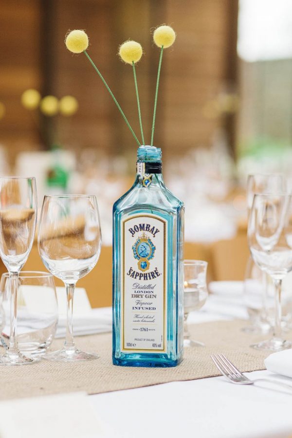 gin bottles as vases available from @theweddingomd rocknrollbride.com - pauljosephphotography.co.uk