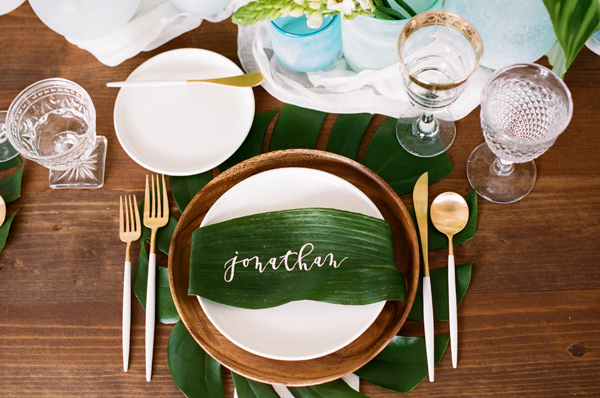 wedding place cards Ruffled - photo by http://kristamason.com/ - http://ruffledblog.com/tropical-leaves-and-sea-glass-wedding-shoot