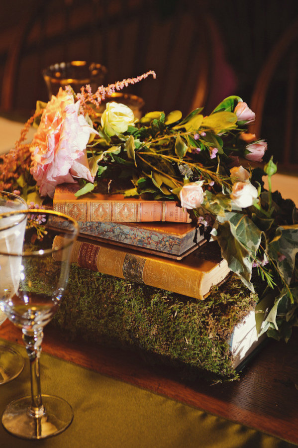 books wedding centrepieces covered in moss