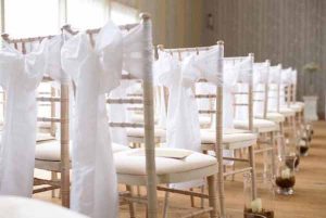 Pink Confetti Petals, Silver Candles & Love Is Sweet Favours Hampton Manor wedding ceremony hurricane lanterns down the aisle