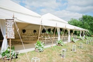 marquee wedding decorations wooden signs lanterns flowers in crates