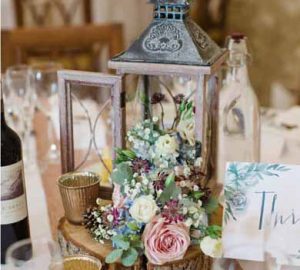 rustic wedding centrepiece for barn tree slices featured