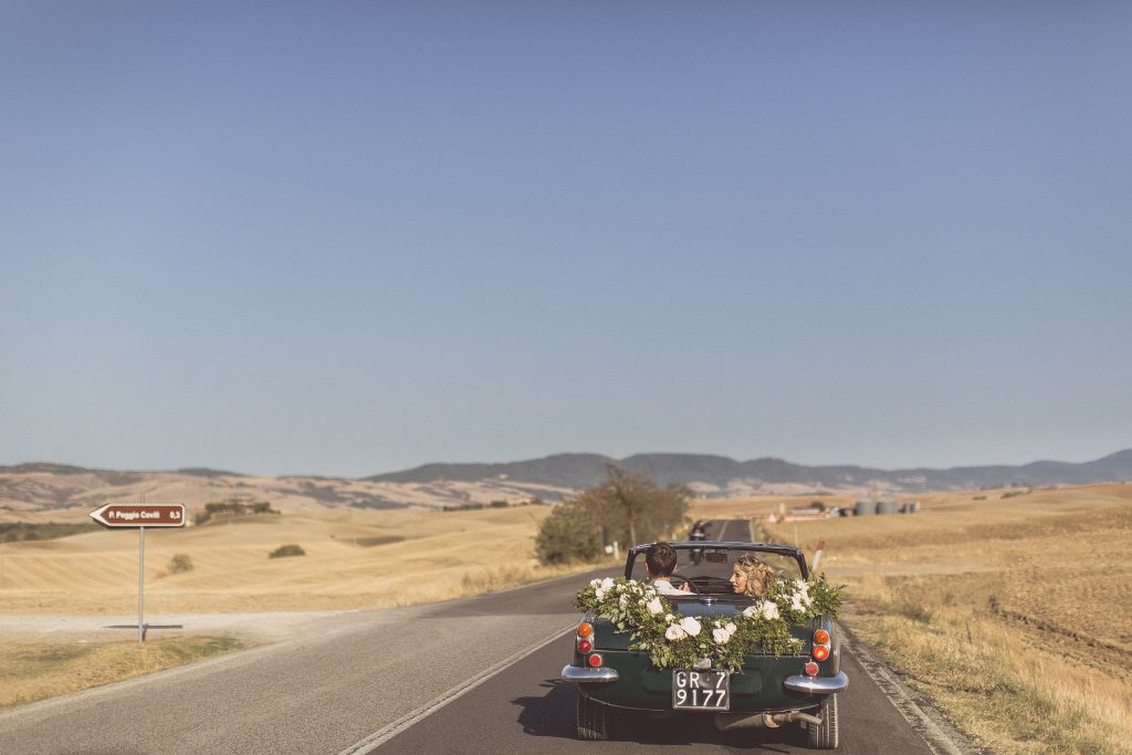 wedding car flower garland vintage sports car soft top Bagno Vignoni Locanda In Tuscany