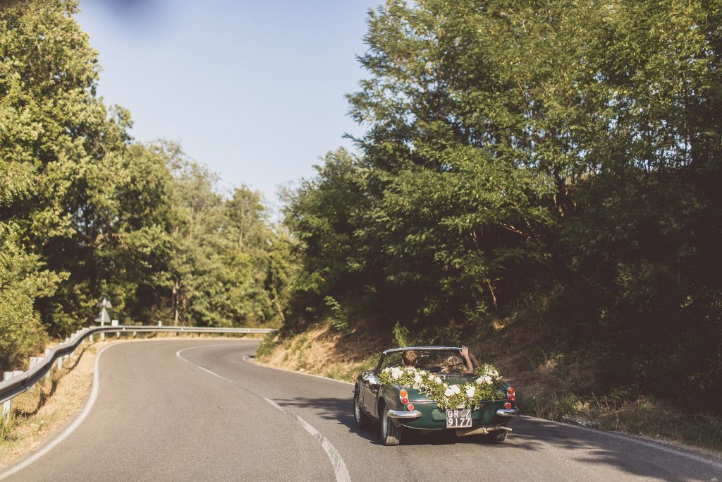 wedding car flower garland vintage sports car soft top Bagno Vignoni Locanda In Tuscany 2