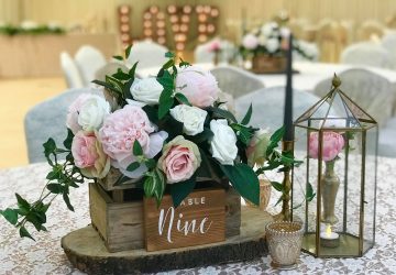 Rustic wedding centrepieces wooden crate on tree slices