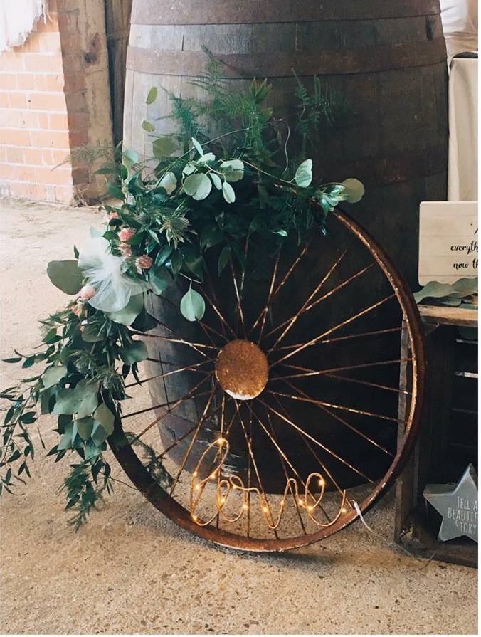 Rustic barn wedding styling wagon wheel cart wheel with foliage and love letters The Wedding of my Dreams