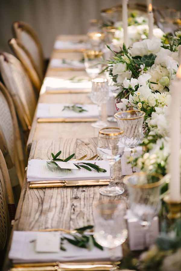 barn wedding centrepieces floral garland with glass and gold details
