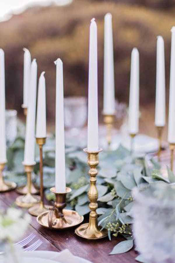 barn wedding gold candlesticks with foliage garlands