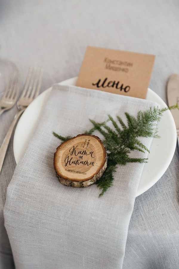 barn wedding place settings wooden tree slices and foliage