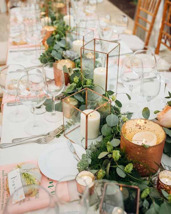 barn wedding with brass lanterns and foliage garlands