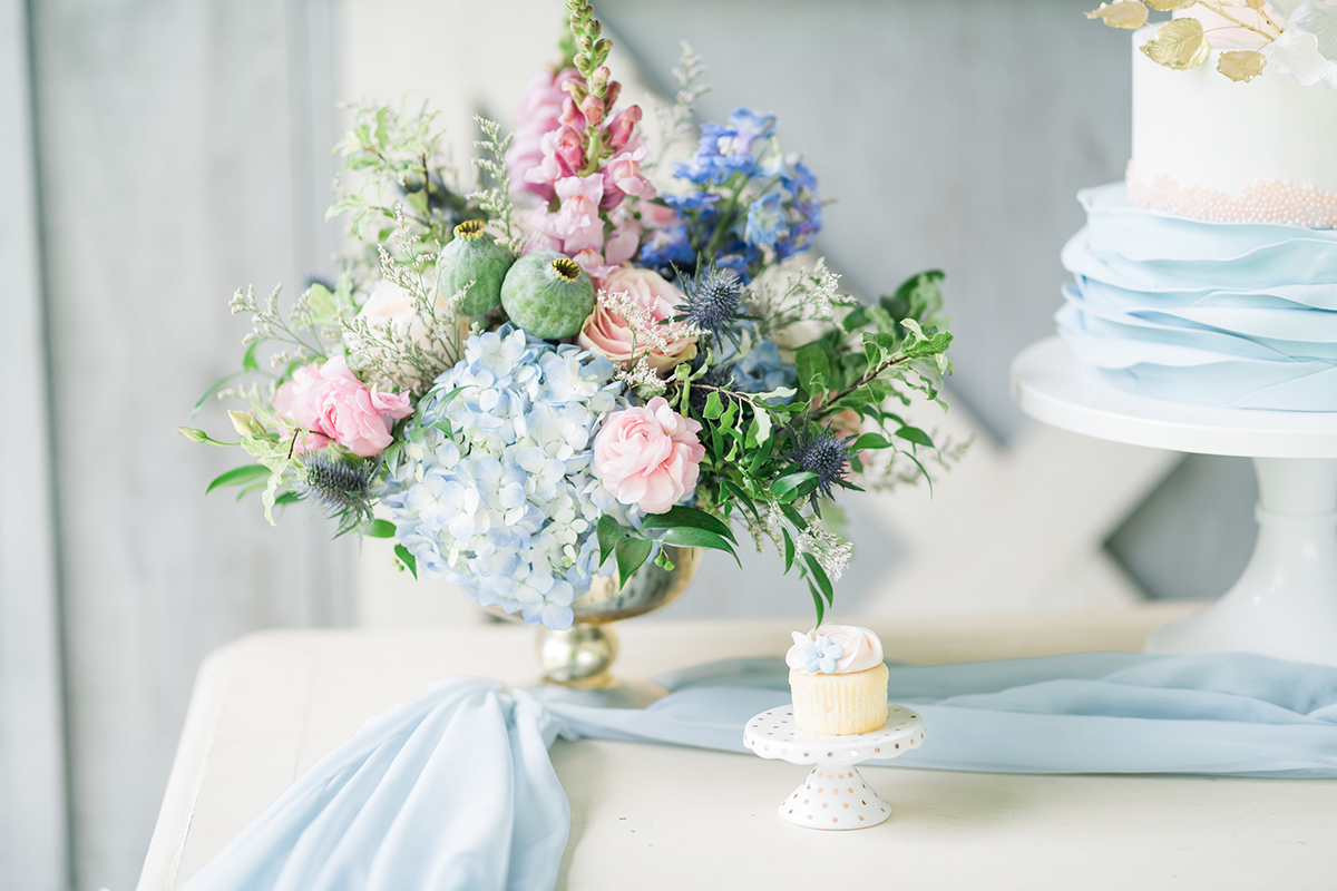 summer barn wedding blue cake table with gold footed bowl wedding flowers centrepieces 2