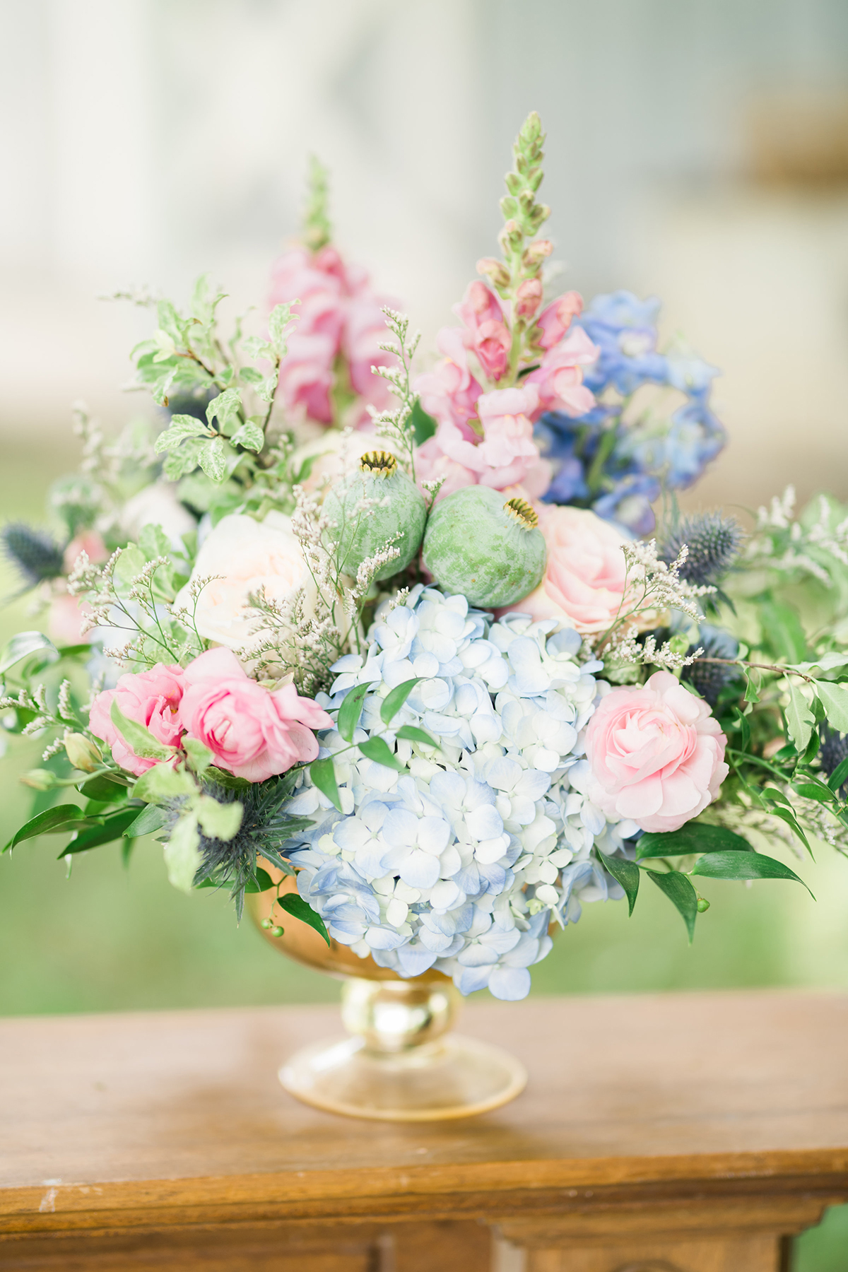 summer wedding centrepieces blue pastel flowers in gold footed bowl centrepieces