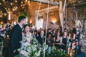 Barn wedding ceremony foliage and candles