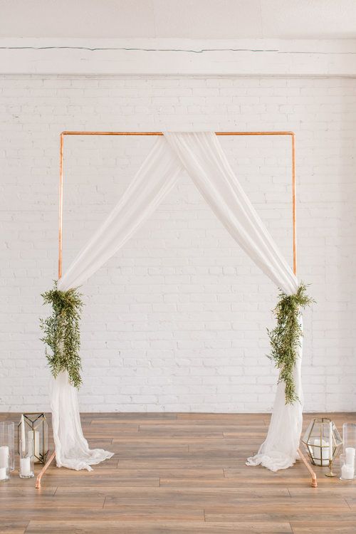 wedding backdrops copper arch drapes and foliage