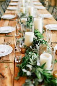 eucalyptus garlands with cylinder vases candles wedding tables