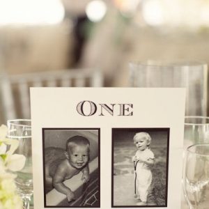 wedding table numbers with photos of the bride and groom at the age