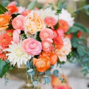 coral wedding centrepieces in gold vases