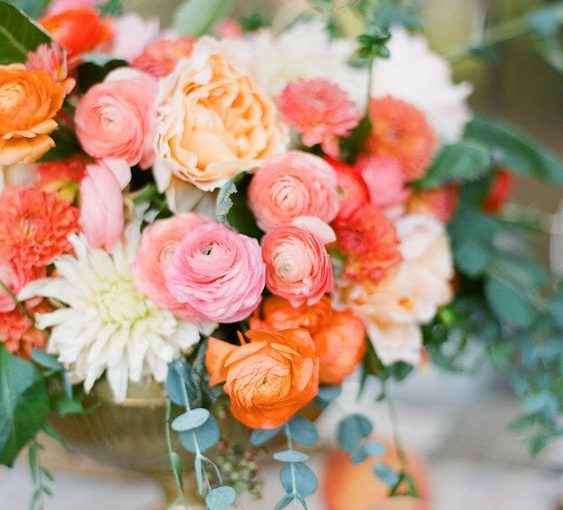 coral wedding centrepieces in gold vases