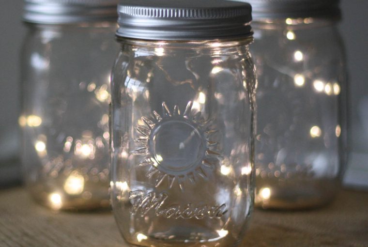 Mason Jar with Fairy Lights on tree slices for centrepieces available from @theweddingomd
