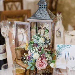 rustic wedding centrepiece for barn tree slices featured