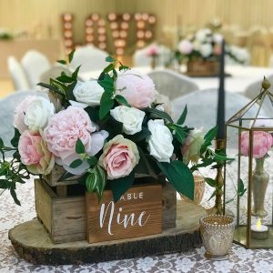Rustic wedding centrepieces wooden crate on tree slices